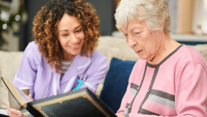 elderly woman reading to a younger woman