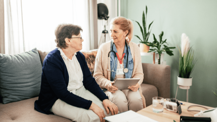 a nurse having a conversation with an old lady