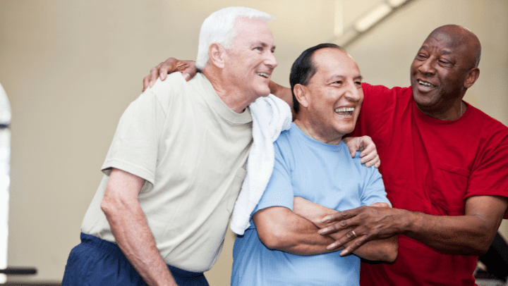 a group of older friends smiling at each other