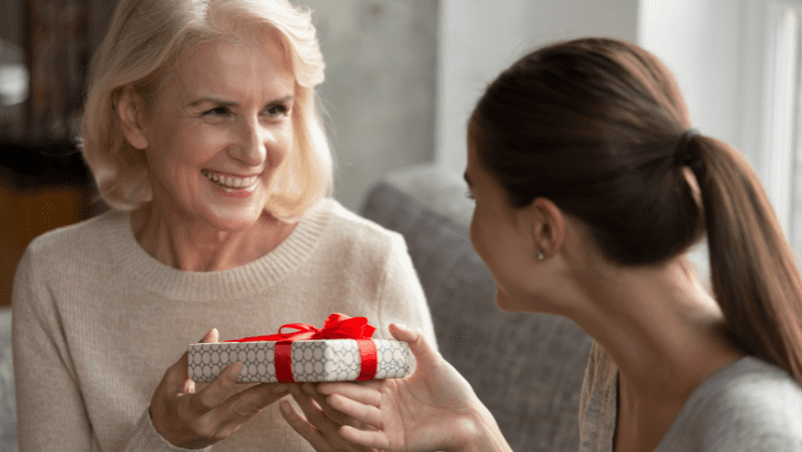 Old woman receiving a gift box