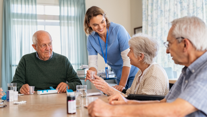 a nurse helping a group of seniors