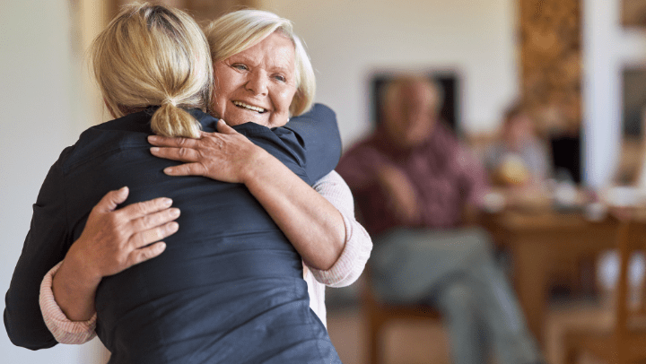 Daughter visits her mother and hug each other