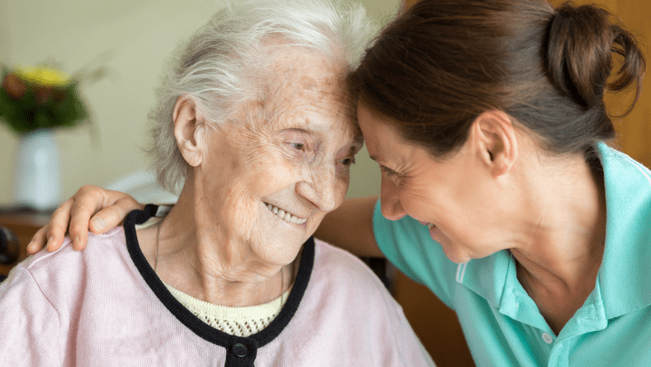 an old lady and her daughter hugging each other 