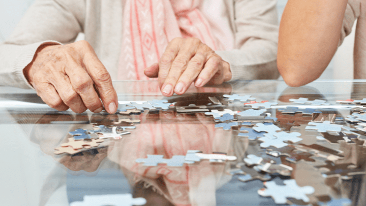 an elderly lady doing a puzzle