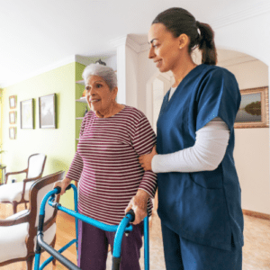 a woman helping an old lady walk 