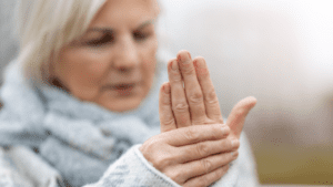 old lady touching her hand