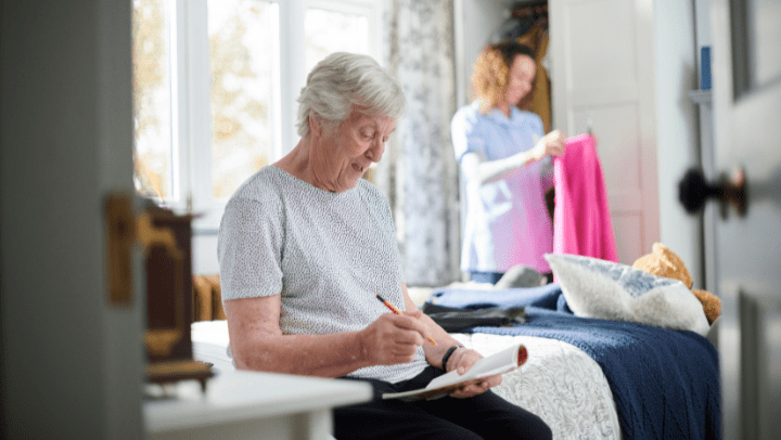 a senior lady writing a letter