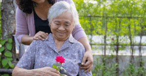senior with caregiver in a garden