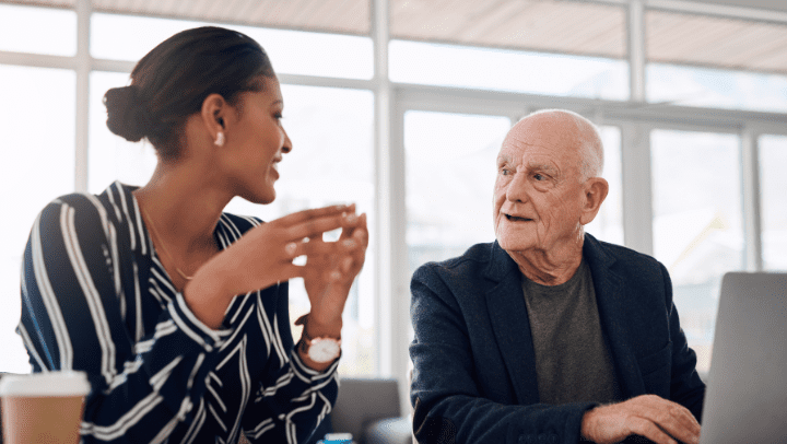 an old man and a young woman talking