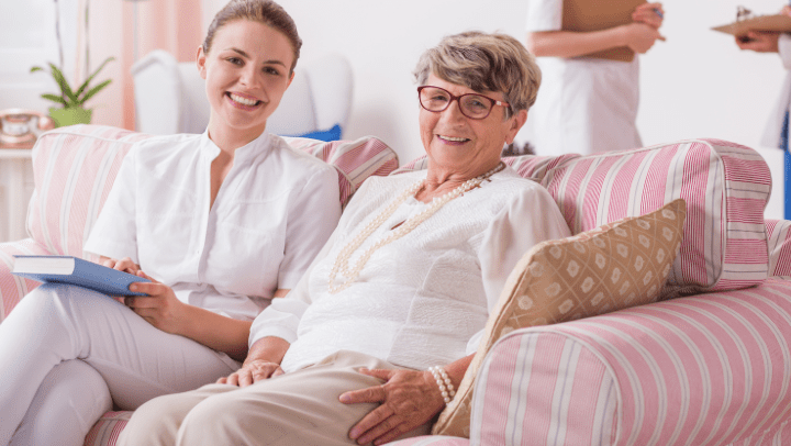 a senior lady smiling with a nurse 