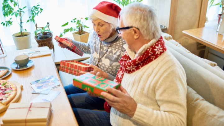 Grandparents opening christmas gifts