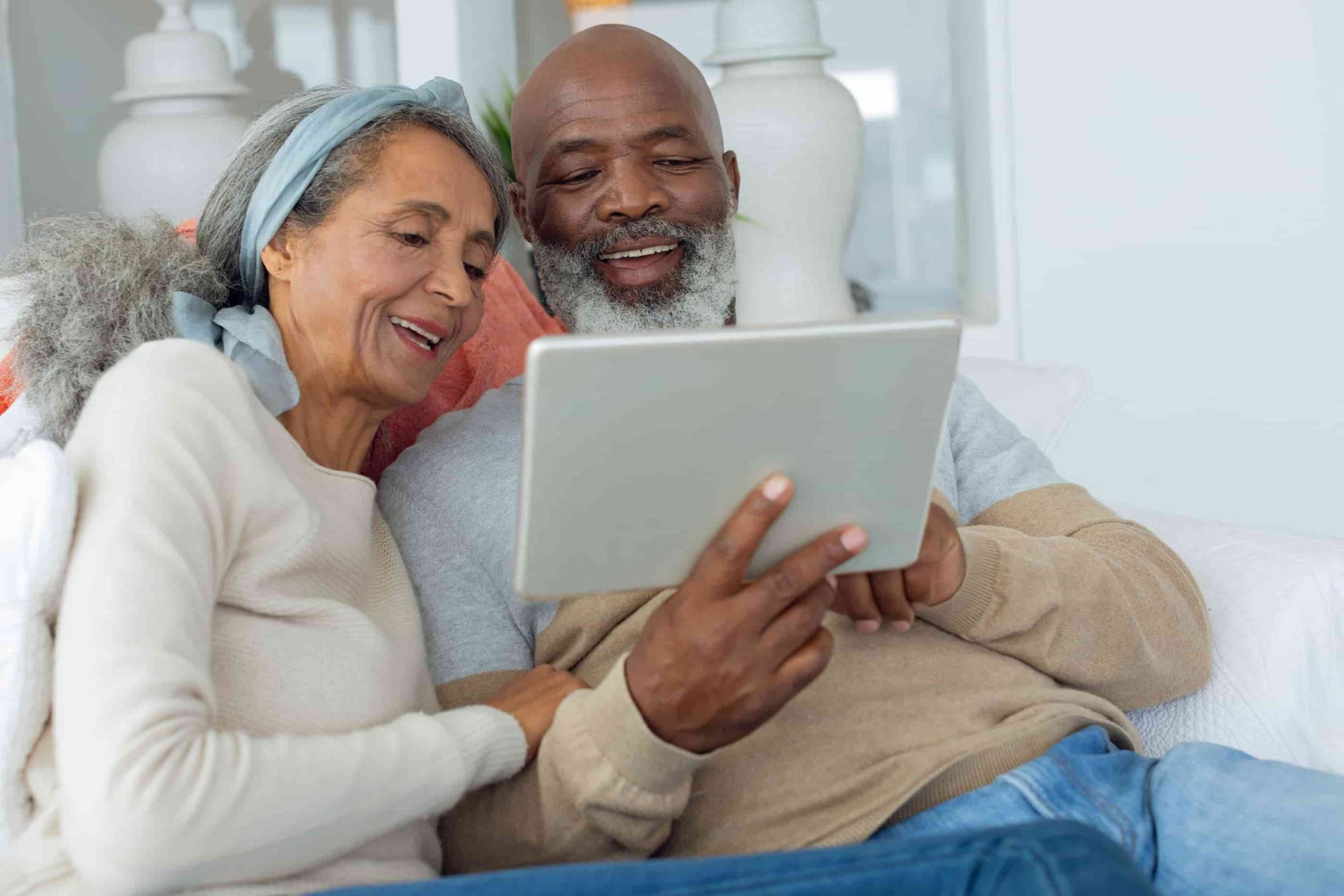 An older adult couple living a senior living lifestyle and enjoying technology.