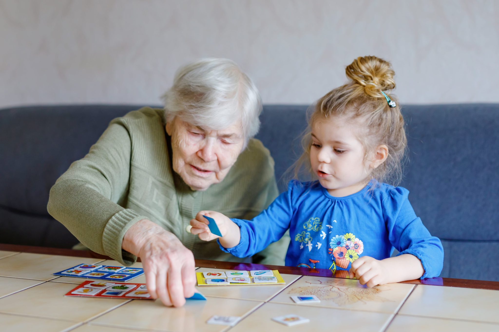 Senior woman with memory difficulties playing with grandchild.