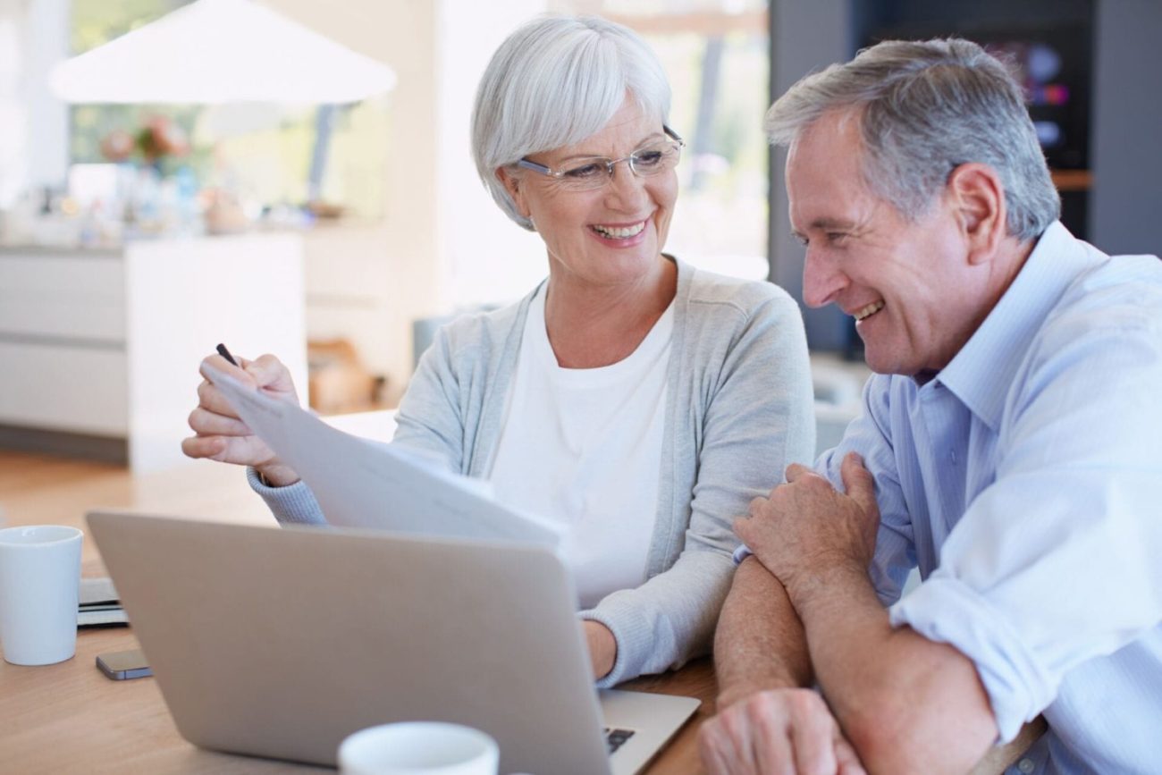 A senior man and woman reviewing finances and preparing for retirement.