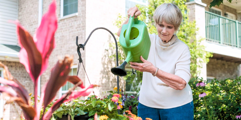 resident watering plants at senior living community in milwaukee