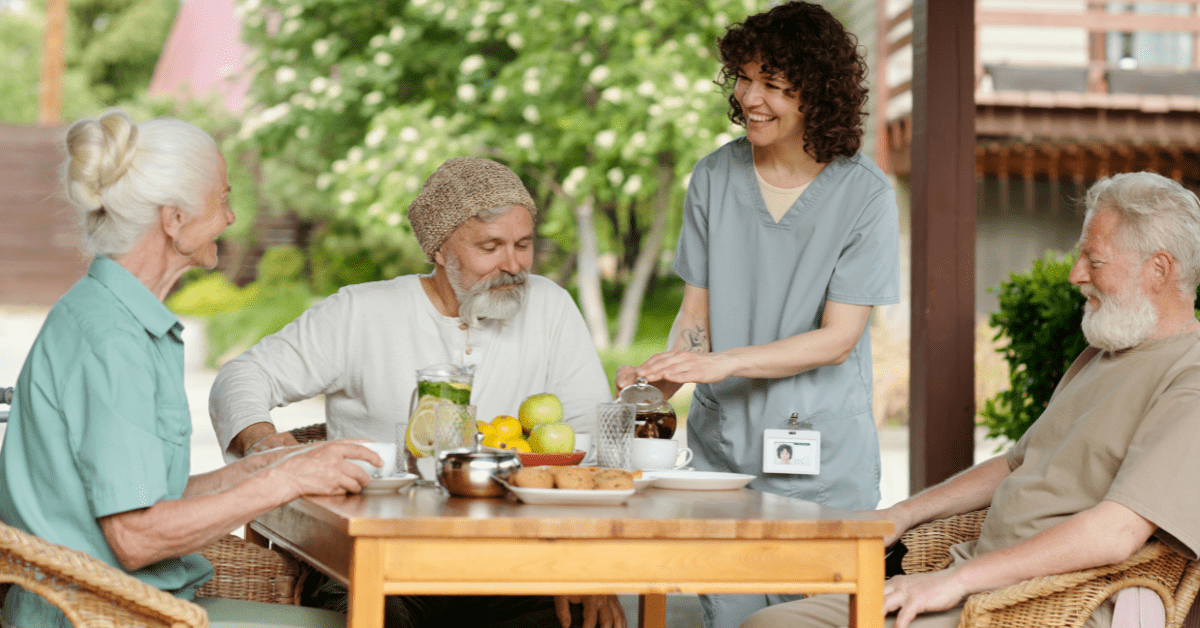 a group of seniors sharing coffee at assisted living