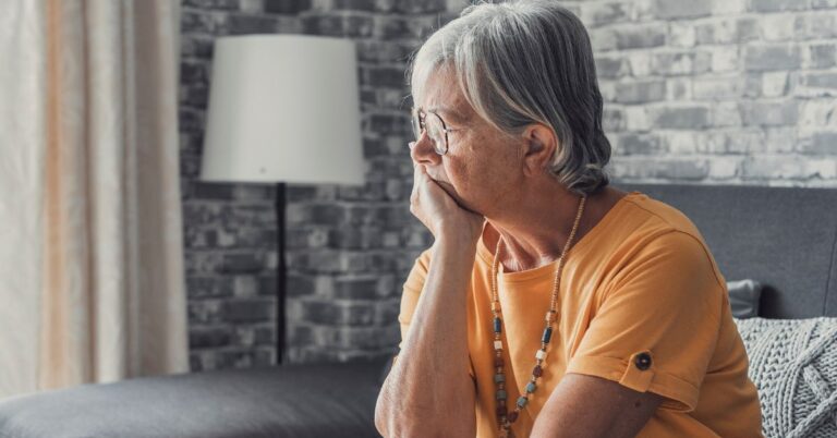 a pensive old woman in her memory care room