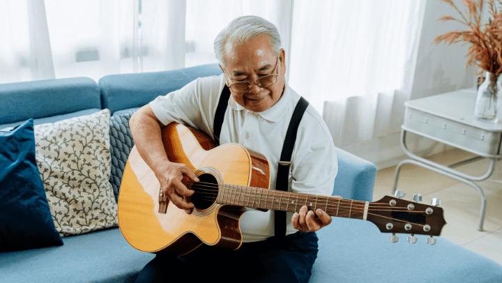 old man playing the guitar