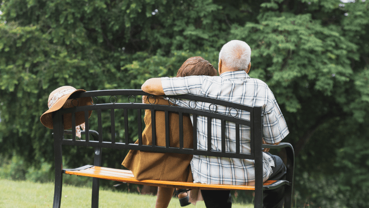 a senior couple sitting on a bench