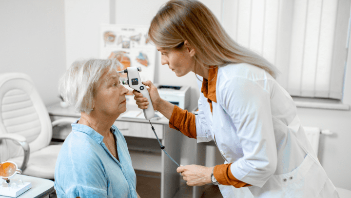 doctor checking the eye of an old lady