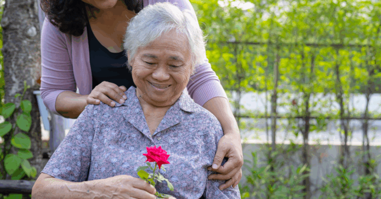 senior with caregiver in a garden