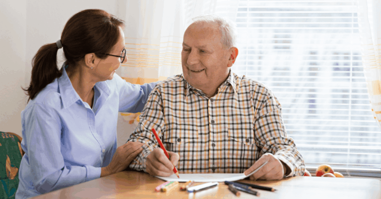a senior drawing with caregiver