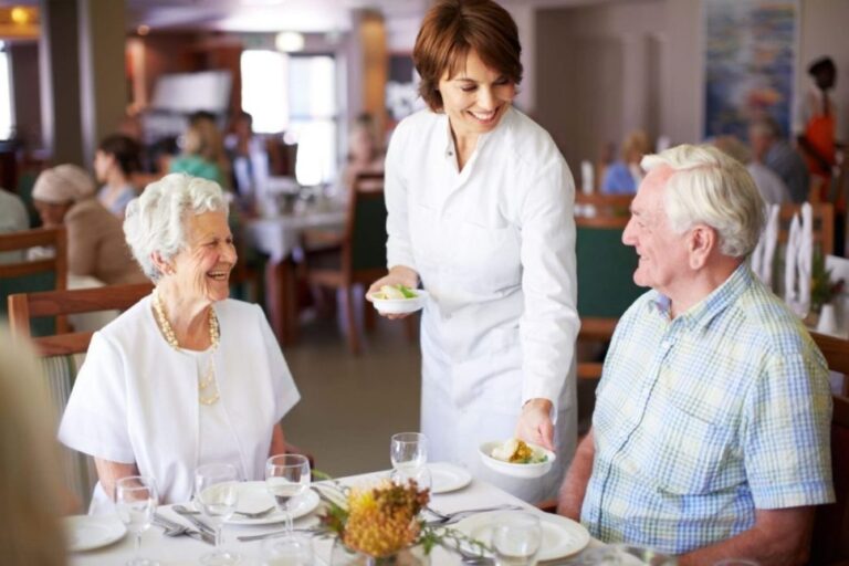 A senior man living with dysphagia and his wife enjoy a meal together.