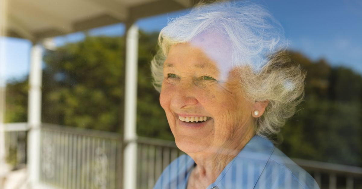 senior looking at the window in assisted living