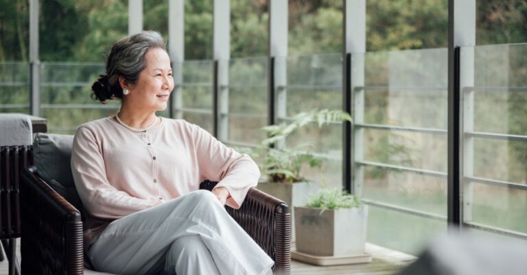 senior looking at the window in assisted living