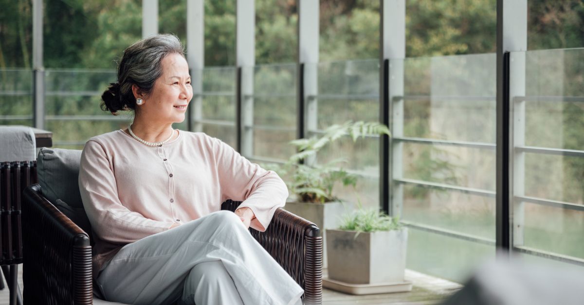 senior looking at the window in assisted living