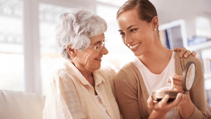 a senior lady smiling to her daughter