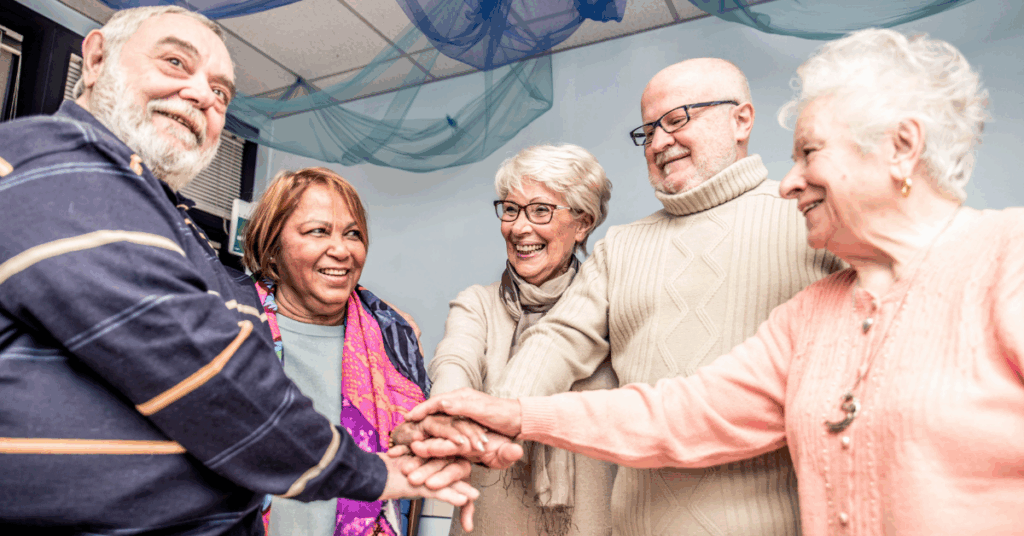 a group of seniors looking happy at memory care