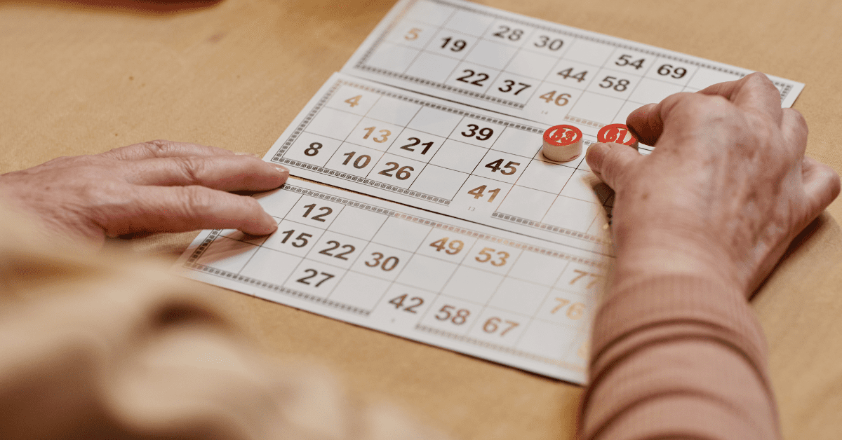 A senior man participating in a board game activity at a memory care community