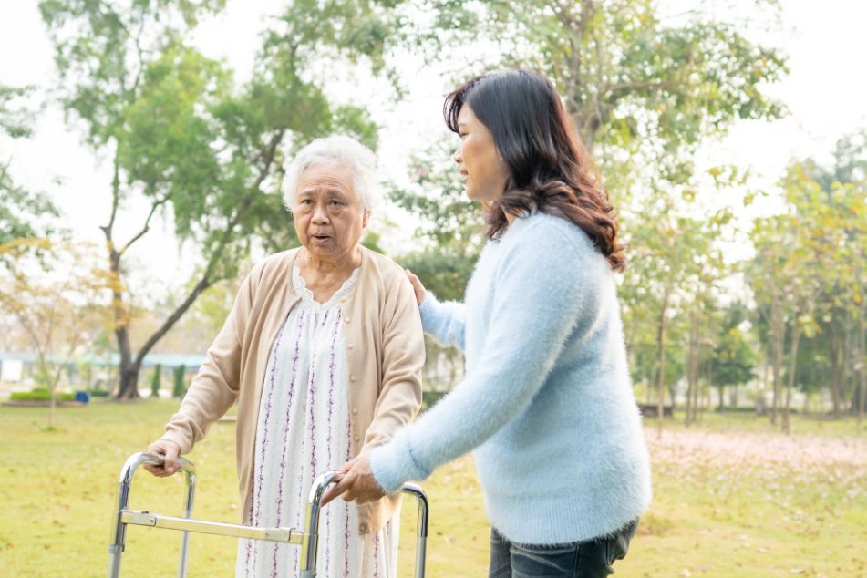 Senior experiences frailty using a walker to get around outside.