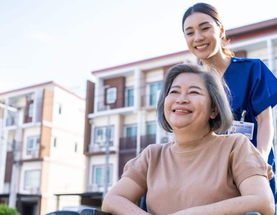 senior-resident-woman-in-enhanced-assisted-living-being-helped-by-nurse