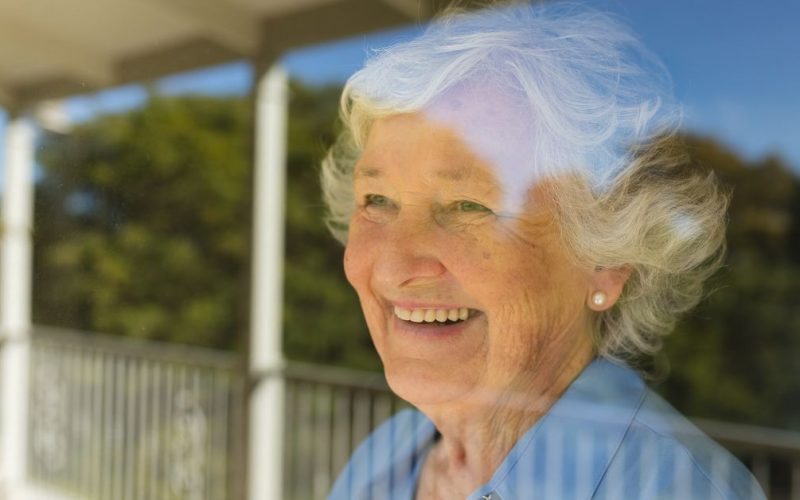 senior looking at the window in assisted living