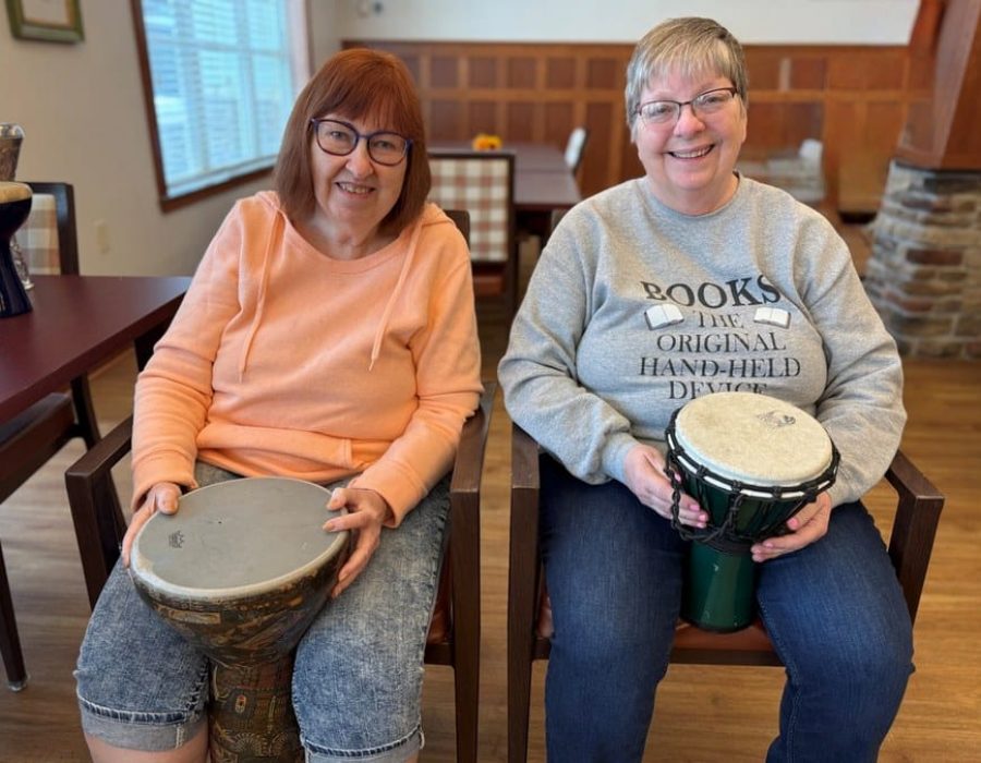 two-happy-senior-residents-in-drumming-activity