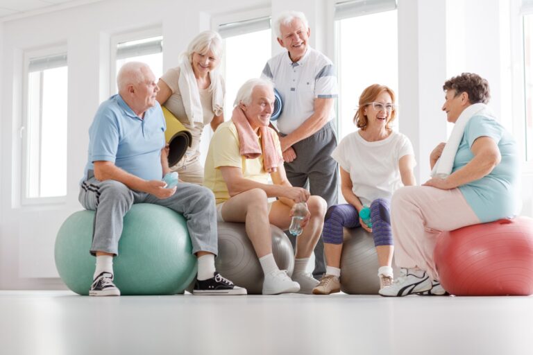 Senior friends exercising together at a gym