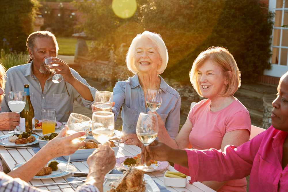 a group of seniors eat and drink together
